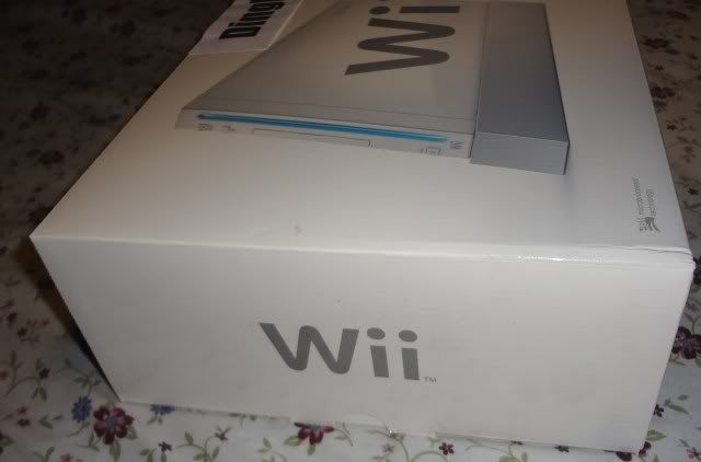 Picture of New, Open Box White Nintendo Wii Console / System with 1 set of controllers (1 Wii Remote and 1 Wii Nunchuck) and accessories only. No games.