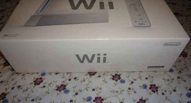 Picture of New, Open Box White Nintendo Wii Console / System with 1 set of controllers (1 Wii Remote and 1 Wii Nunchuck) and accessories only. No games.