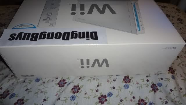 Picture of New, Open Box White Nintendo Wii Console / System with 1 set of controllers (1 Wii Remote and 1 Wii Nunchuck) and accessories only. No games.